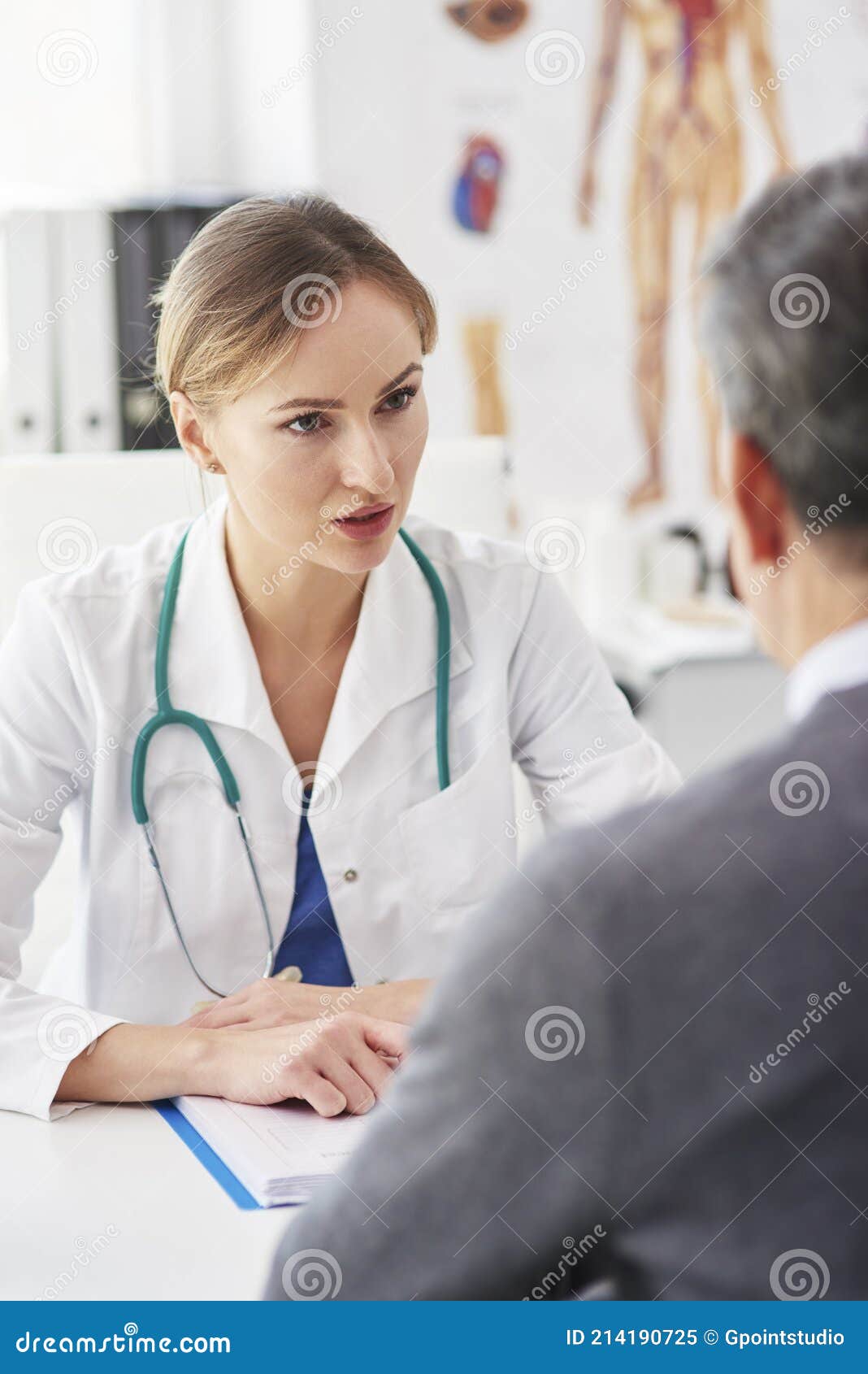 female doctor talking to her patient in doctorÃ¢â¬â¢s office